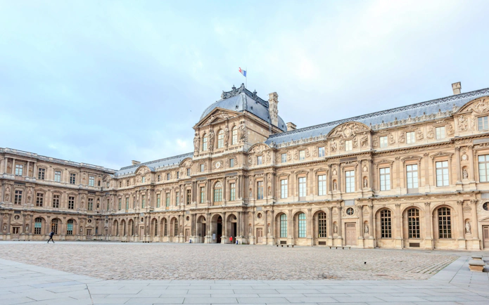 Louvre Museum courtyard in Paris during a walking tour.