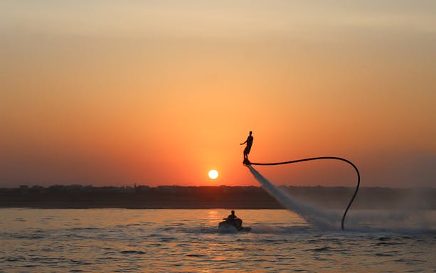 Flyboarder soaring over the sea at sunset near Hurghada.
