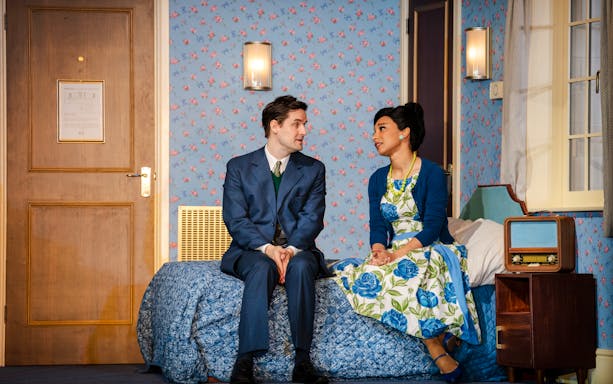 Actors in a vintage room scene from "The Comedy About Spies" production.