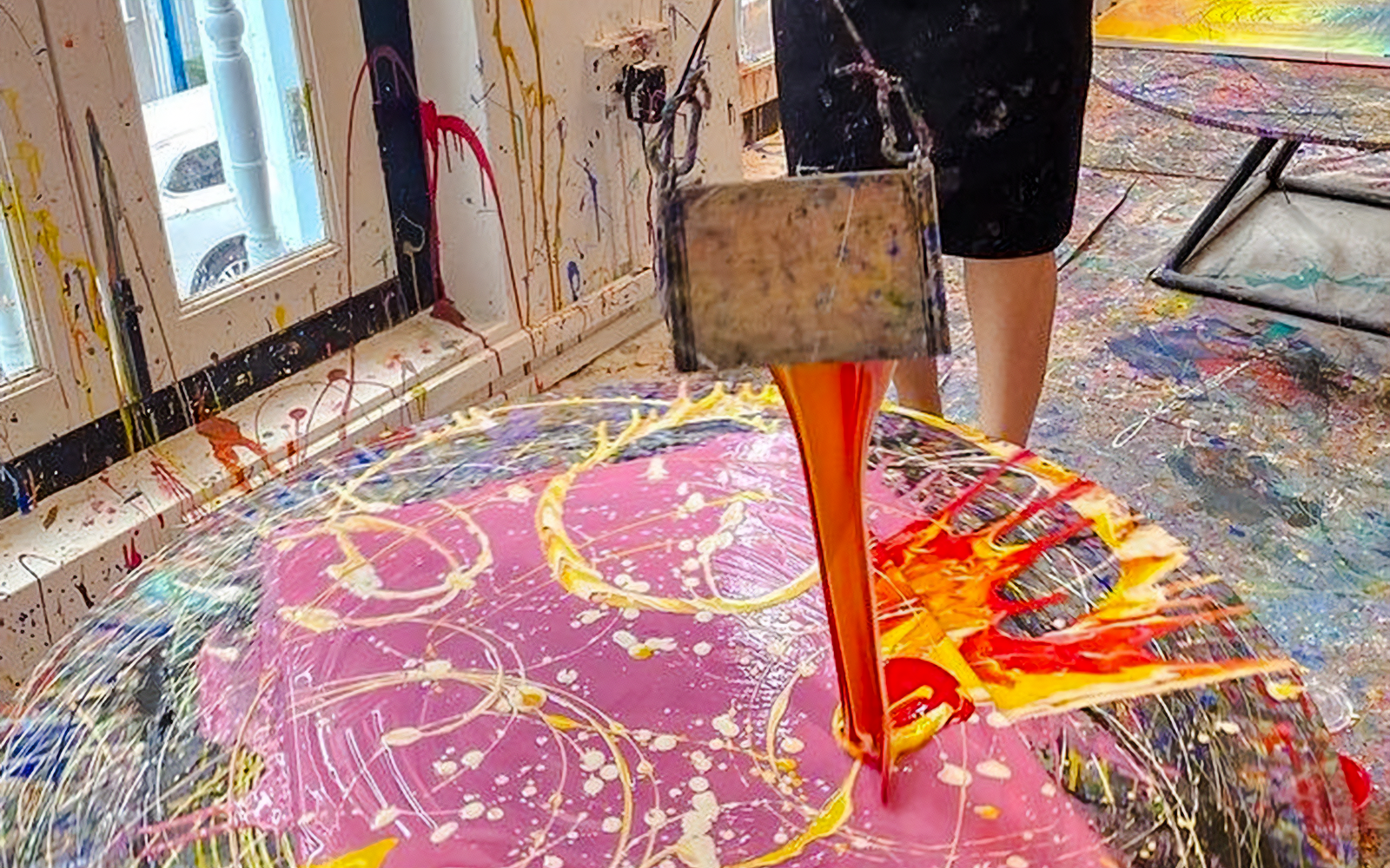 Pouring paint onto spinning canvas at Motion Art Space Singapore.