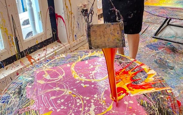 Pouring paint onto spinning canvas at Motion Art Space Singapore.