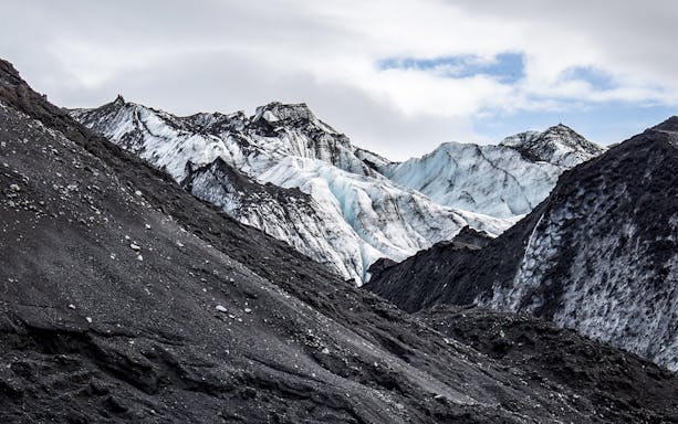 Mýrdalsjökull glacier with rugged ice formations and volcanic ash, Iceland.
