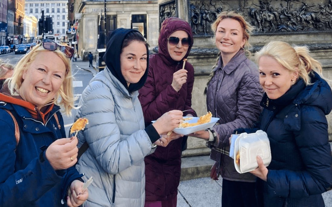 Guests enjoying local cuisine on a Glasgow food tour.