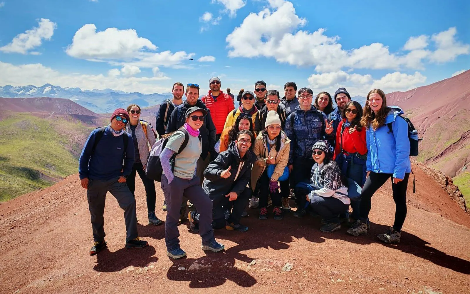 Group of tourists on Rainbow Mountain during ATV tour in Red Valley, Peru.