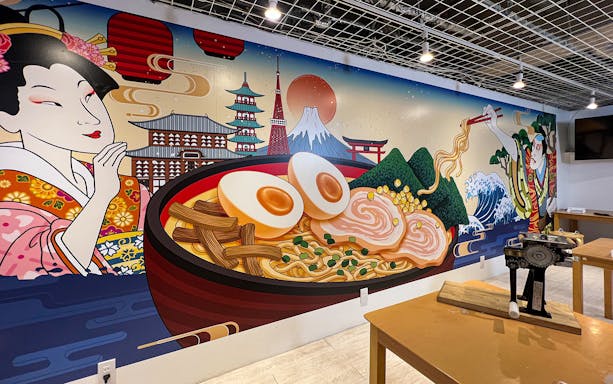 Mural of ramen bowl with Kyoto landmarks at Ramen Factory Kyoto cooking class.