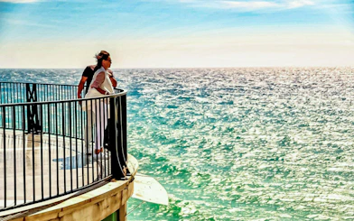 People enjoying ocean views from Balcón de Europa, Nerja, Spain.