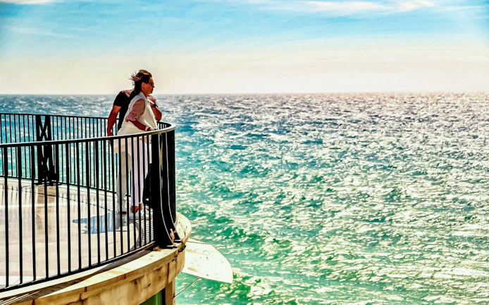 People enjoying ocean views from Balcón de Europa, Nerja, Spain.