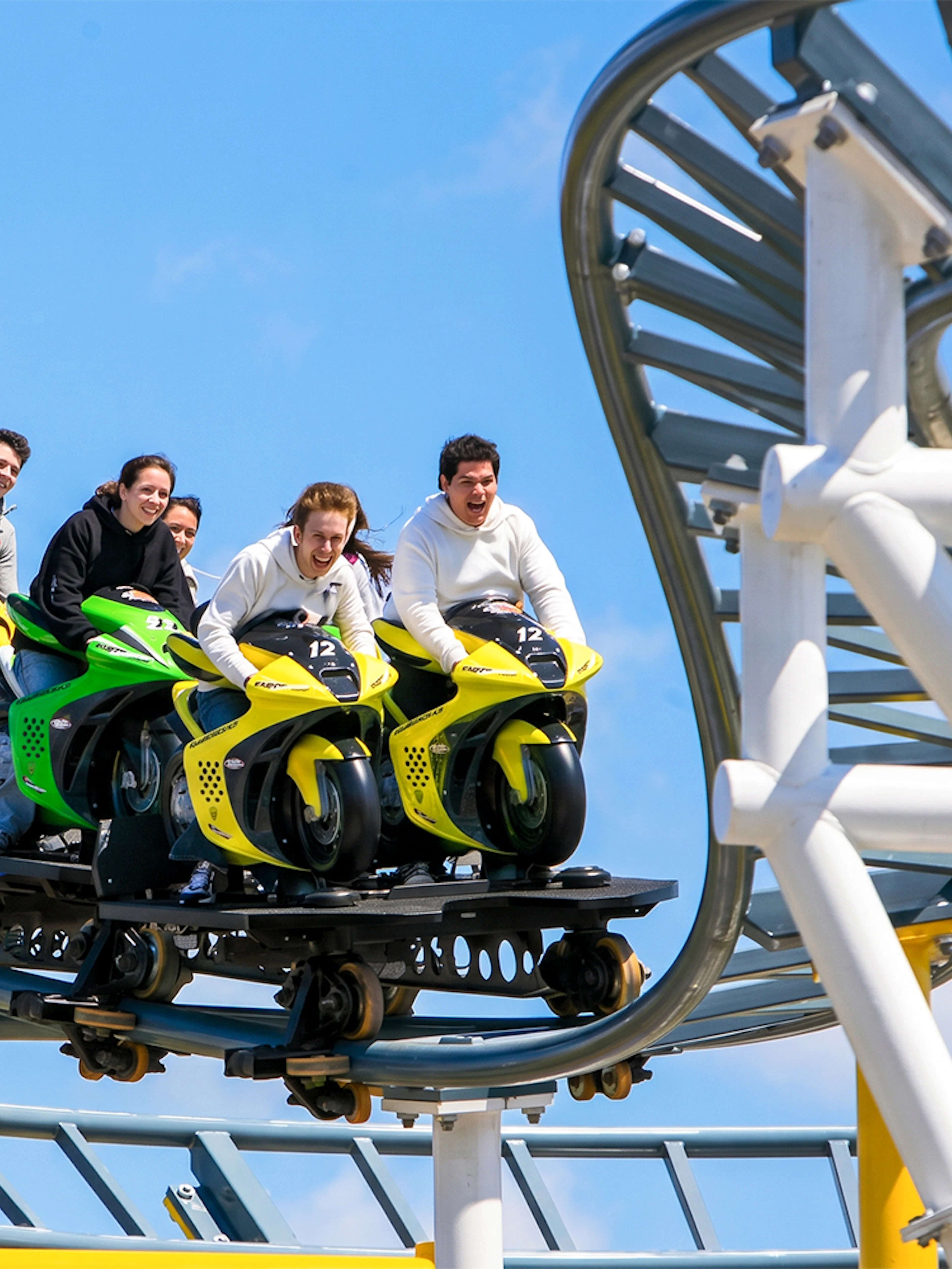 Riders on the Motocoaster at Six Flags Darien Lake, experiencing a thrilling ride.