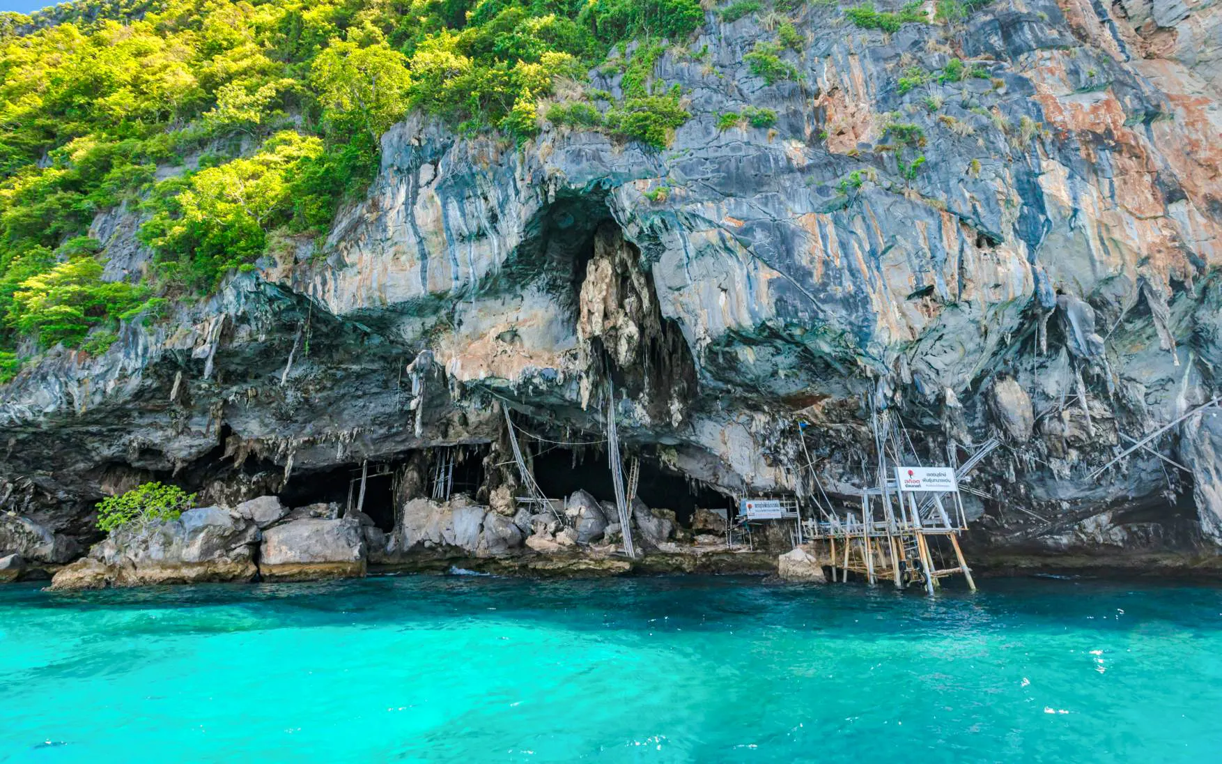 Rocky cliffs and turquoise waters at Phi Phi Islands, part of the Phuket catamaran tour.