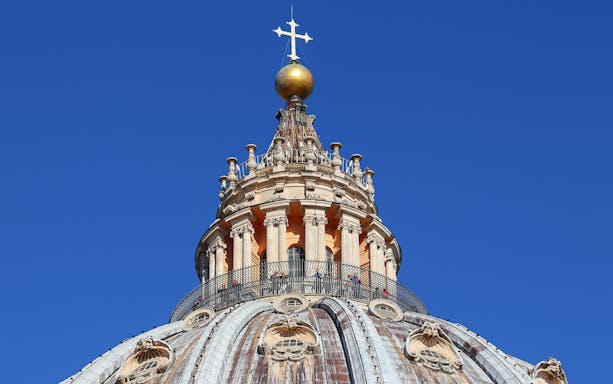 Upper dome of St. Peter's Basilica with cross and balustrade, Vatican City.