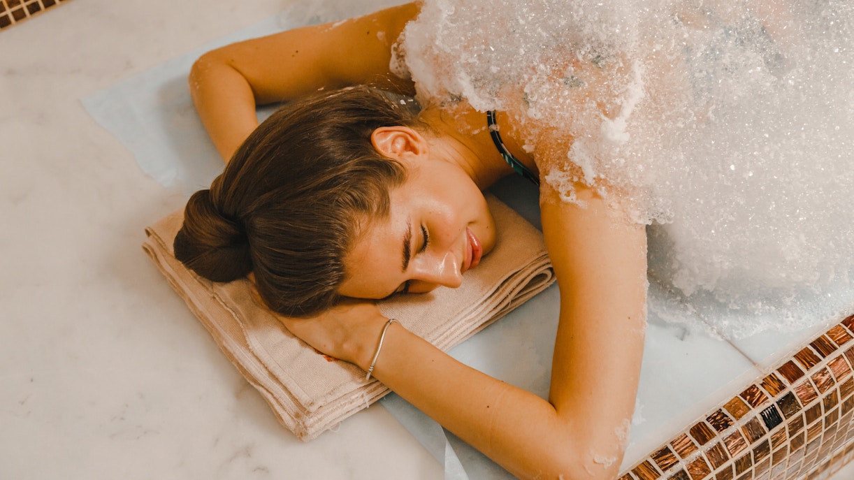 Woman receiving foam massage in a Turkish hammam.