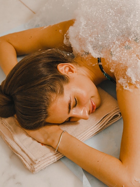 Woman receiving foam massage in a Turkish hammam.