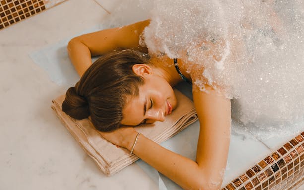 Woman receiving foam massage in a Turkish hammam.