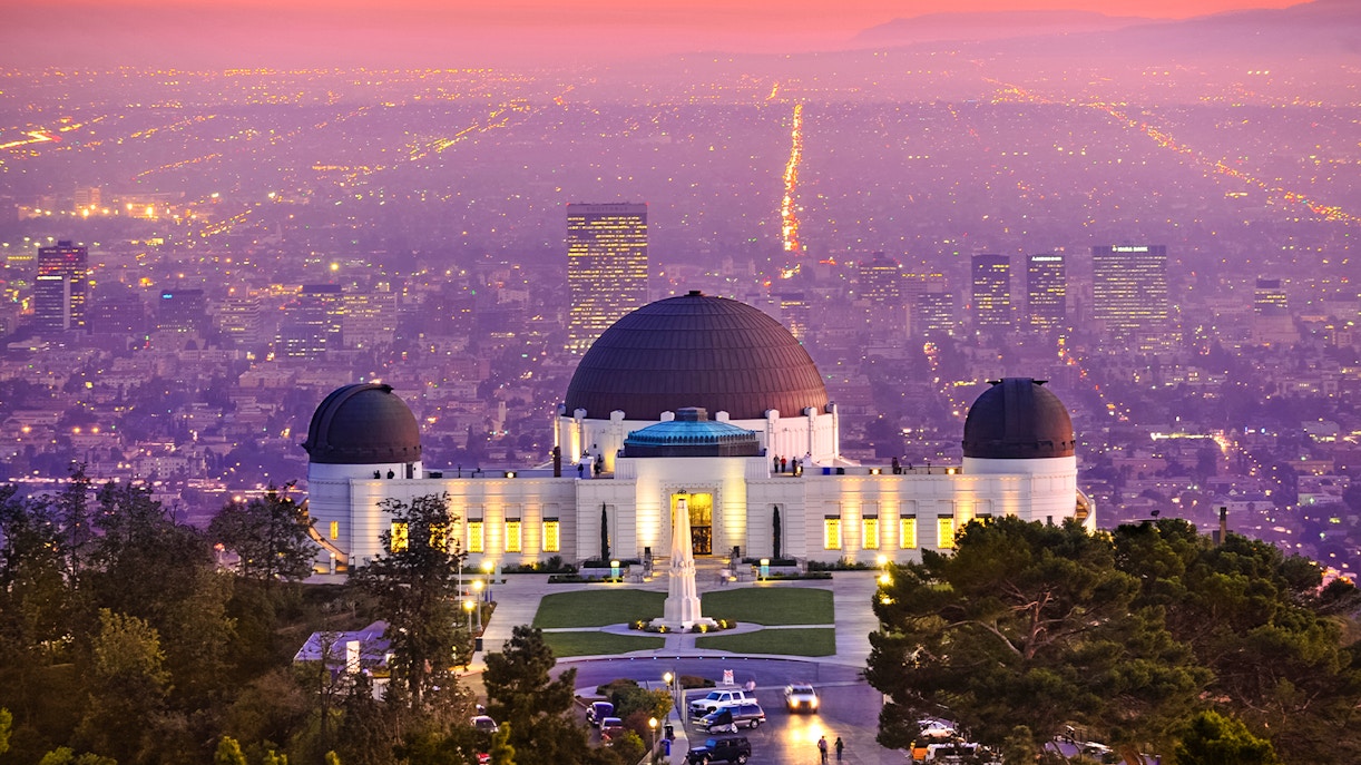 Griffith Observatory overlooking Los Angeles cityscape at sunset.