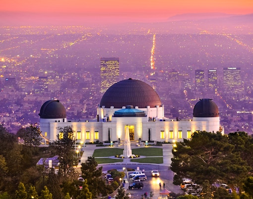 Griffith Observatory overlooking Los Angeles cityscape at sunset.