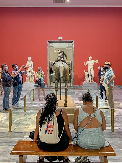 Visitors viewing sculptures at the National Archaeological Museum.