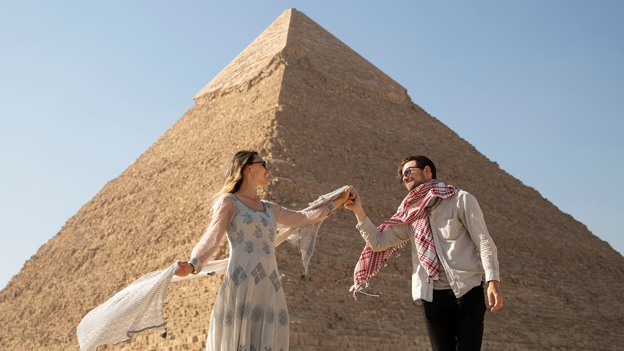Couple enjoying a private tour in front of the Great Pyramid of Giza, Cairo.