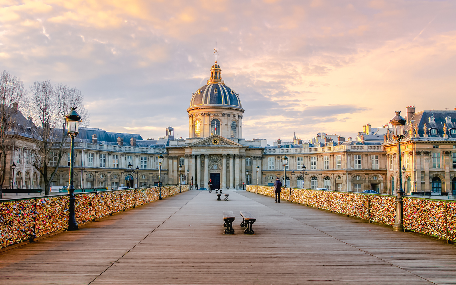 Pont des Arts bridge with love locks and Institut de France in Paris.