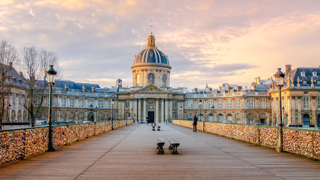 Pont des Arts bridge with love locks and Institut de France in Paris.