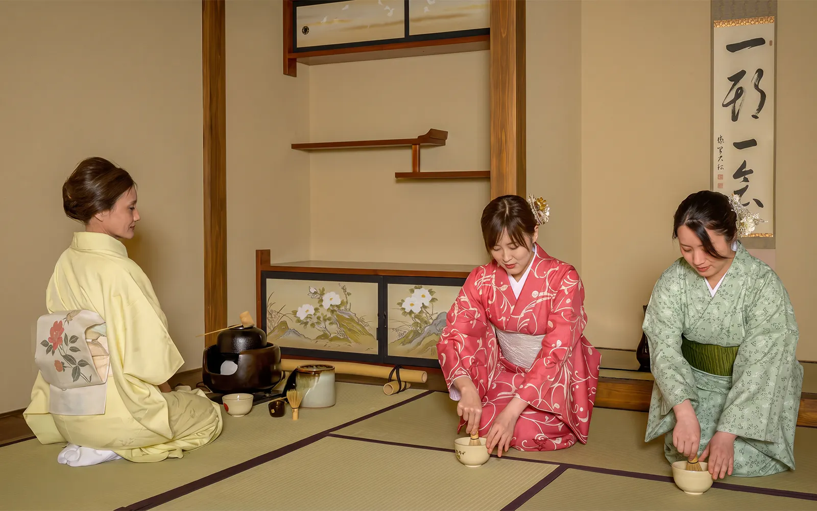 Women in kimonos performing a tea ceremony in Shinjuku, Japan.
