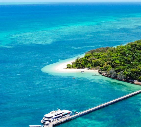 Green Island cruise boat on clear waters near Cairns, Australia.