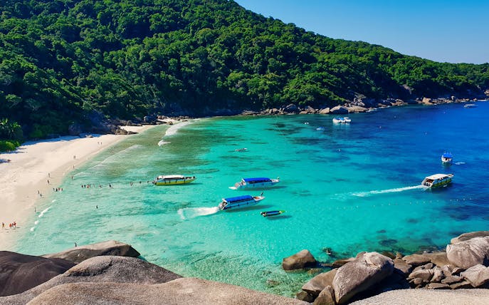 Speed boats and snorkelers in turquoise waters at Similan Islands, Phuket.
