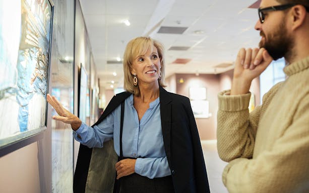 Guide explaining artwork during a museum tour.