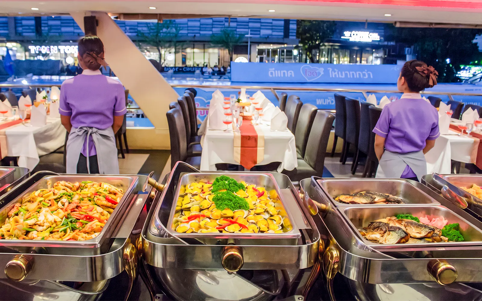 Buffet setup on Chao Phraya Princess dinner cruise during Loy Krathong festival in Bangkok.