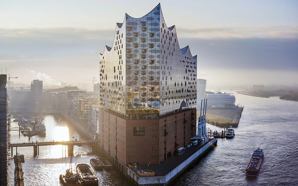 Elbphilharmonie Plaza overlooking Hamburg Harbor with boats on the water.