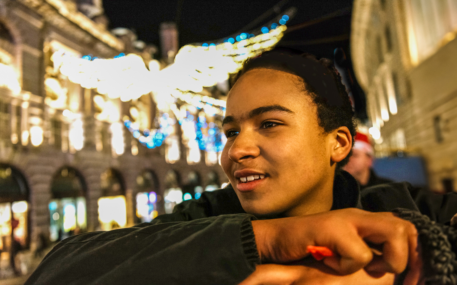 Person enjoying London Christmas lights from Tootbus double-decker tour.