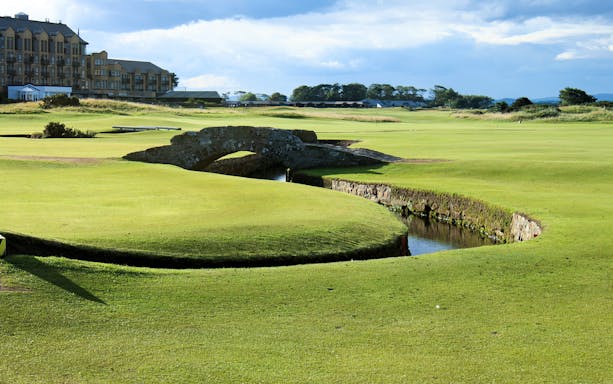 St Andrews golf course with iconic stone bridge and clubhouse in the background, Scotland.