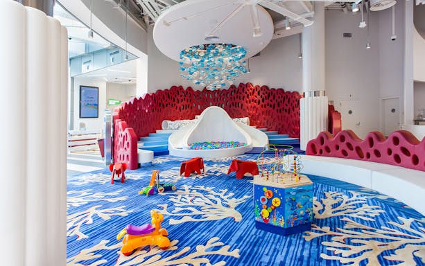 Indoor play area with colorful toys and a slide at Macau Kids City.