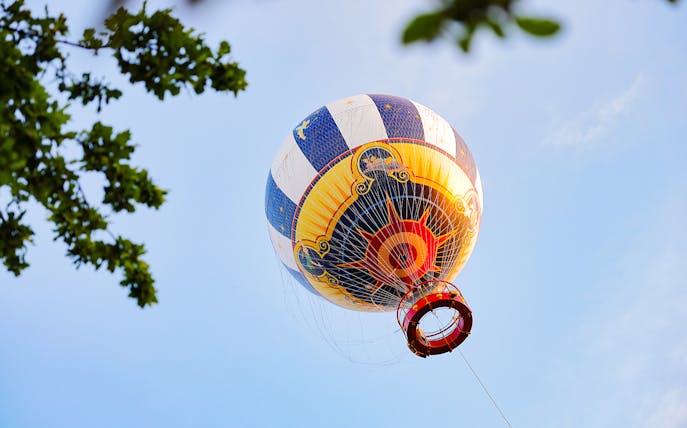 Ballon Panoramagique hot air balloon against blue sky in Paris.