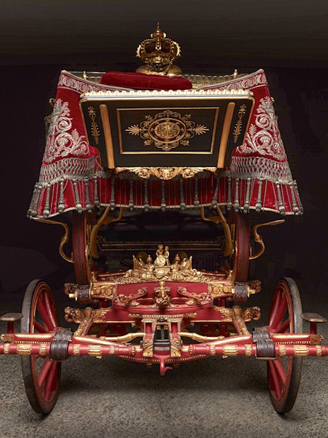 Ornate royal carriage on display at the Royal Collections Gallery.
