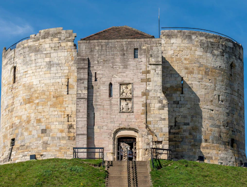 Cliffords Tower Norman Castle in York with stone walls and entrance staircase.