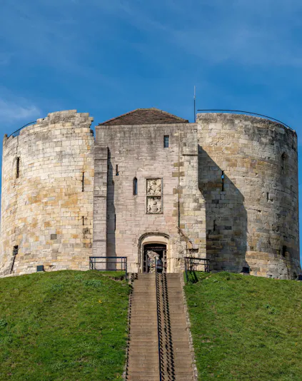 Cliffords Tower Norman Castle in York with stone walls and entrance staircase.