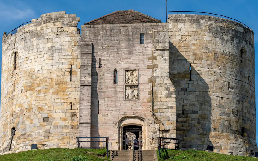 Cliffords Tower Norman Castle in York with stone walls and entrance staircase.