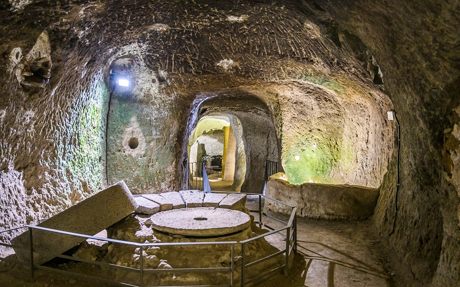 Orvieto Underground cave with ancient millstone and stone walls.