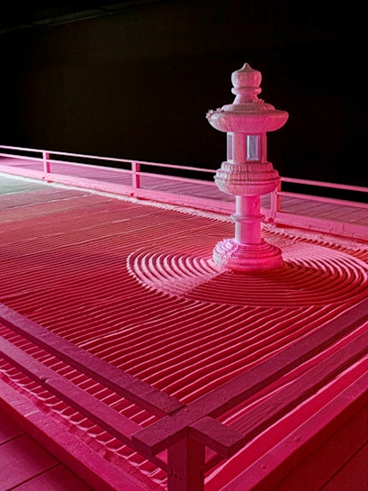 Zen garden with stone lantern at Moco Museum London exhibit.