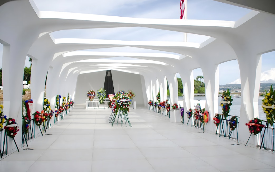 USS Arizona Memorial with floral wreaths in Pearl Harbor, Hawaii.