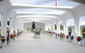 USS Arizona Memorial with floral wreaths in Pearl Harbor, Hawaii.