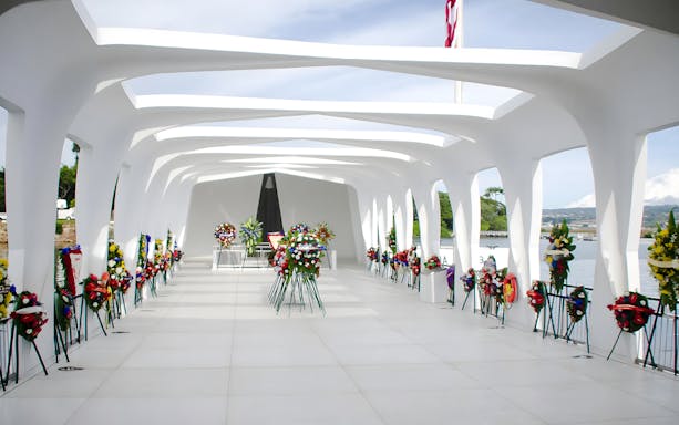 USS Arizona Memorial with floral wreaths in Pearl Harbor, Hawaii.
