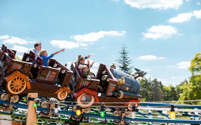 Roller coaster ride at Efteling theme park with excited passengers.