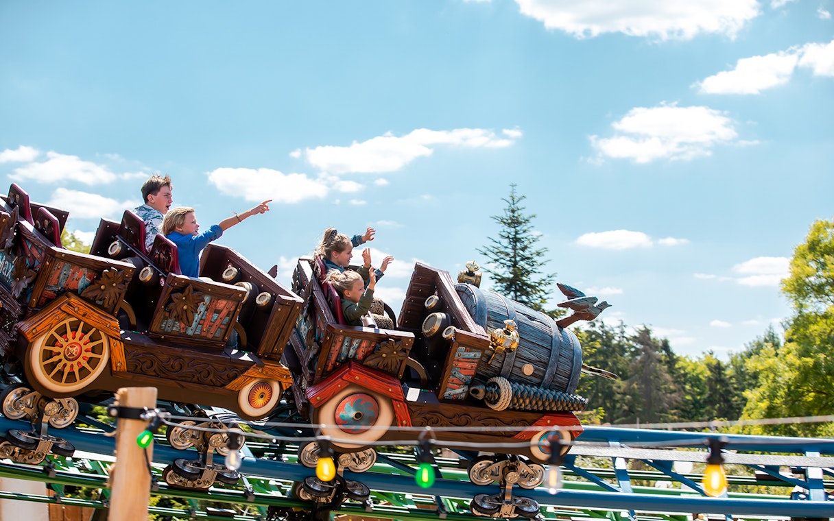 Roller coaster ride at Efteling theme park with excited passengers.