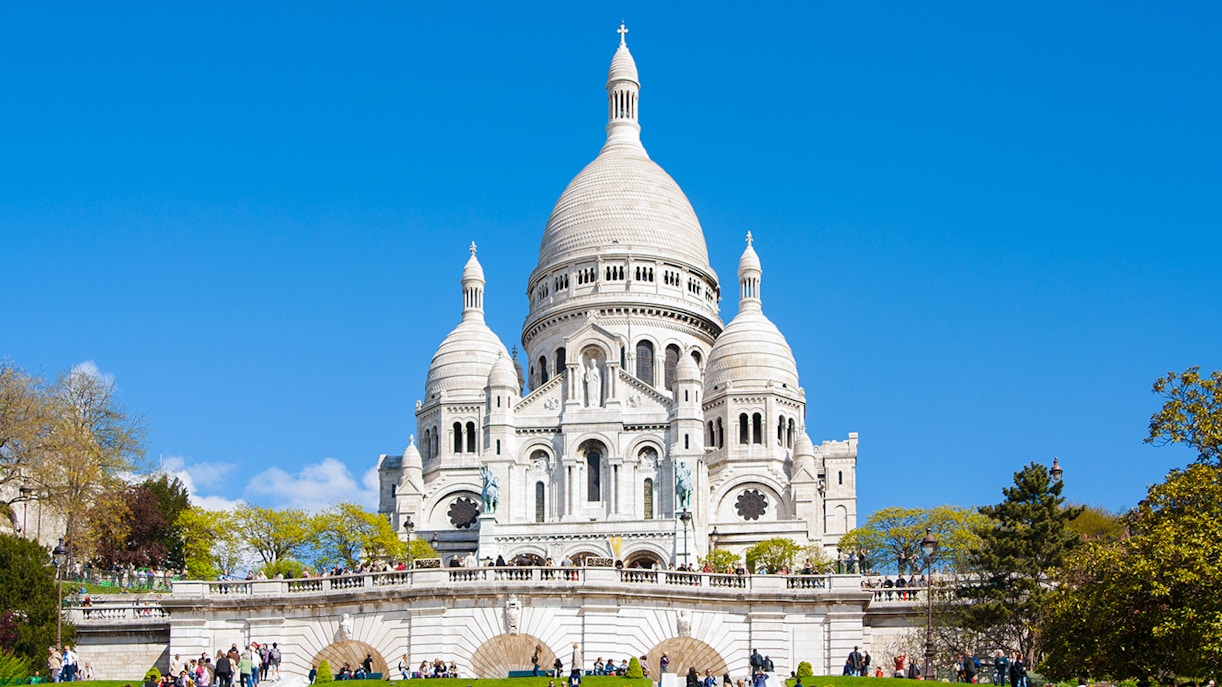 Montmartre Sacre Coeur Cathedral with Paris cityscape in the background.