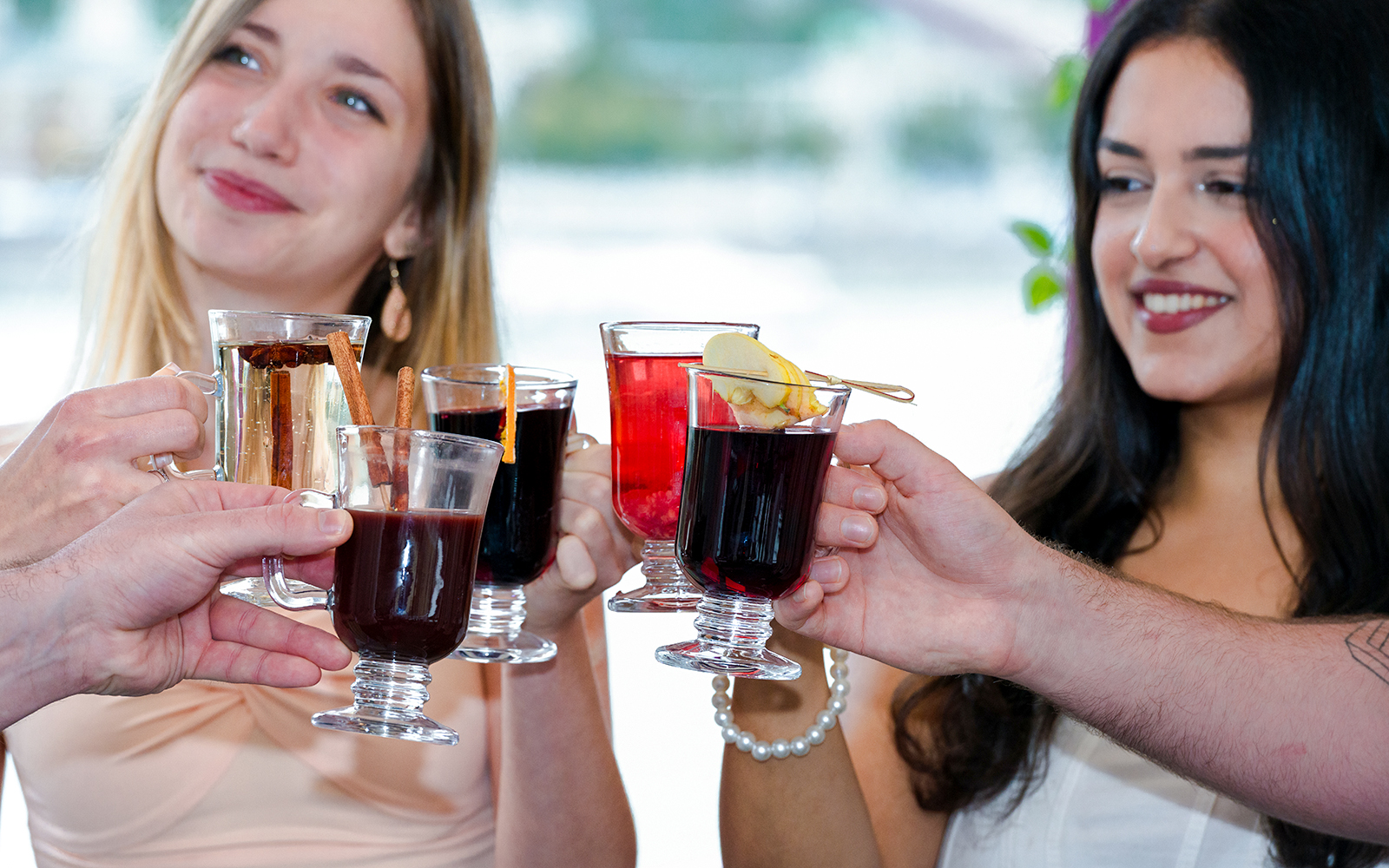 Group toasting with mulled wine on Danube River nighttime sightseeing cruise.