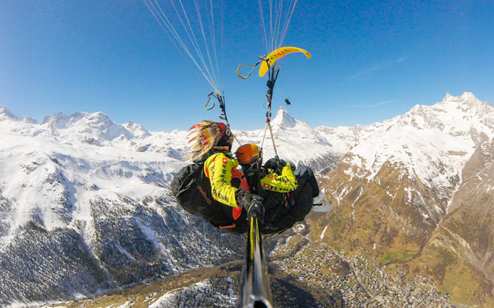 Paragliding over snowy Matterhorn with guide in Switzerland.