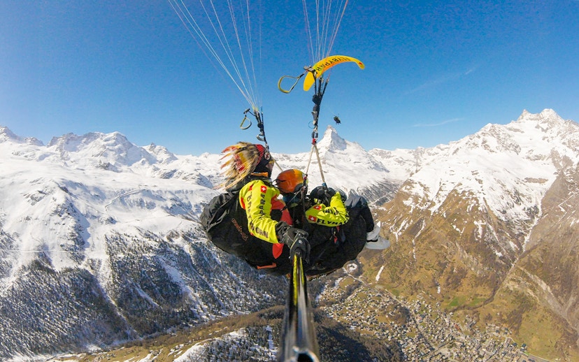 Paragliding over snowy Matterhorn with guide in Switzerland.