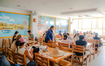 Guests dining at a restaurant during Guatapé & El Peñol Full-Day Tour.