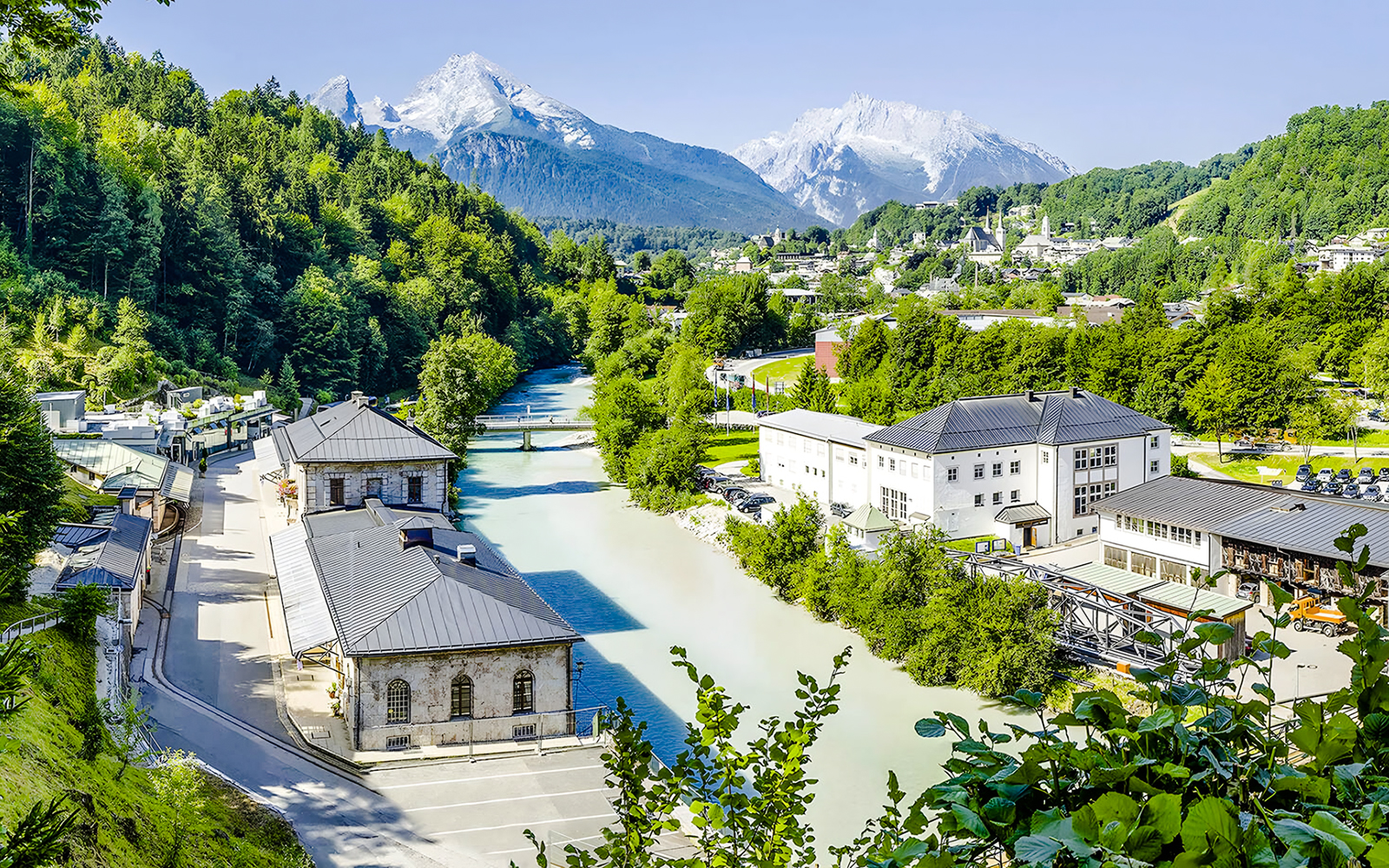 Aerial view of Berchtesgaden Salt Mine in Bavaria with surrounding mountains and river.